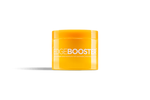 A bright yellow jar of Edge Booster extra strength hair pomade sits against a black background. 
