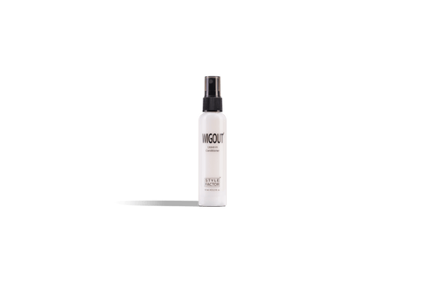 A white bottle of Wigout Leave-in Conditioner with a black spray nozzle stands against a black background. 
